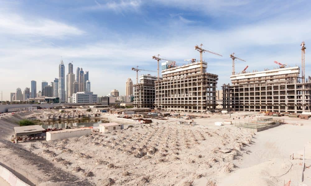 Large urban construction site with cranes and high-rise buildings representing areas where LiDAR mapping and drone surveying are used