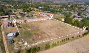 Aerial view of a property with clearly marked boundary lines explaining why a lot survey is often needed after land use updates
