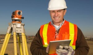 Licensed land surveyor conducting elevation measurements for a Flood Elevation Certificate