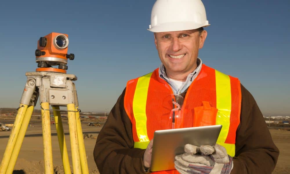 Licensed land surveyor conducting elevation measurements for a Flood Elevation Certificate 