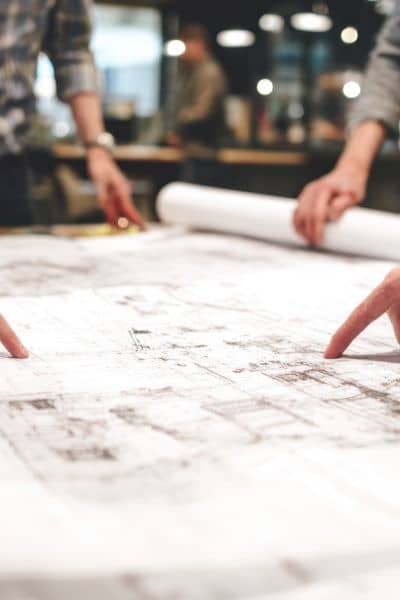 Team reviewing site plans and property boundaries for an alta land title survey project

