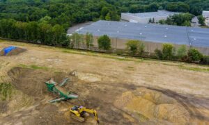 A drone land surveying aerial view of an active construction site with earthwork and site grading