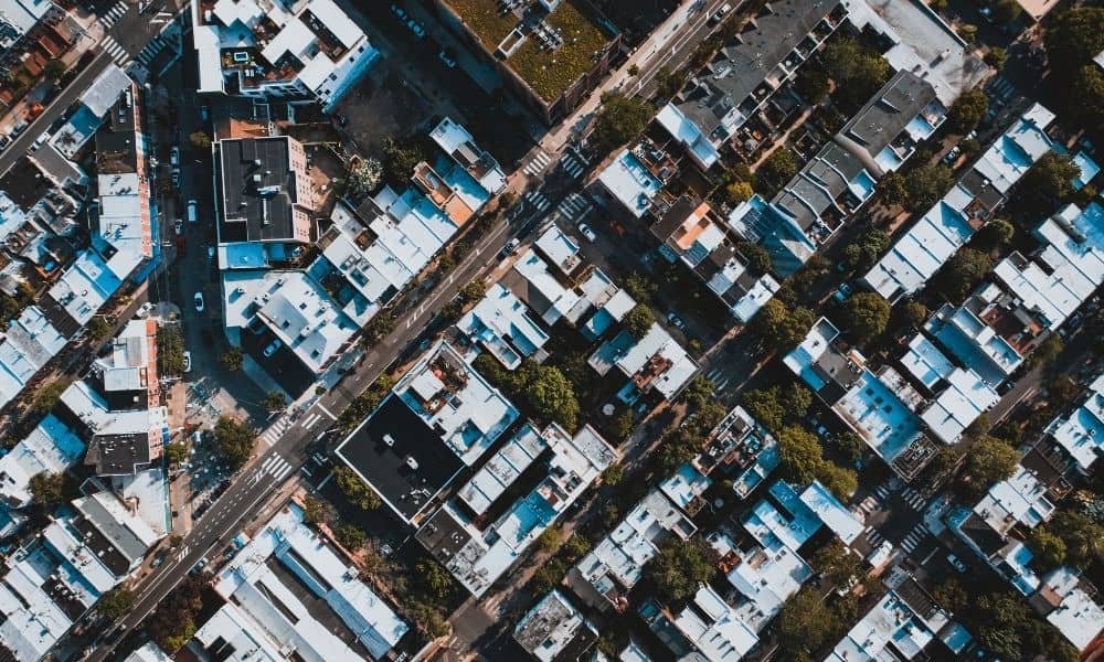 Aerial view of closely spaced Philadelphia homes and streets, showing the existing building footprints a residential survey measures for lot coverage and setback planning